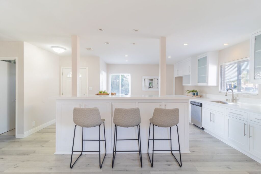 Bright and spacious modern kitchen with white accents and minimalist design.