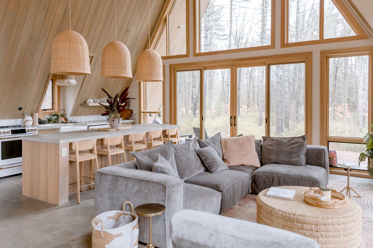 Warm and inviting modern cabin interior featuring a stylish open kitchen and living area.